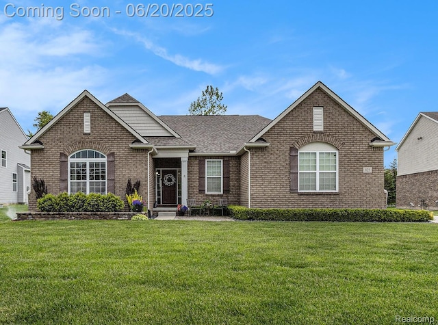 825 Mcintosh Ct, Oakland, MI 48363 - view of front of home with brick siding, a shingled roof, and a front yard