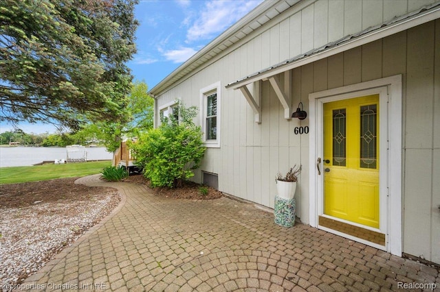 600 Wolverine Dr, Walled Lake, MI 48390 - property entrance with a water view and a patio