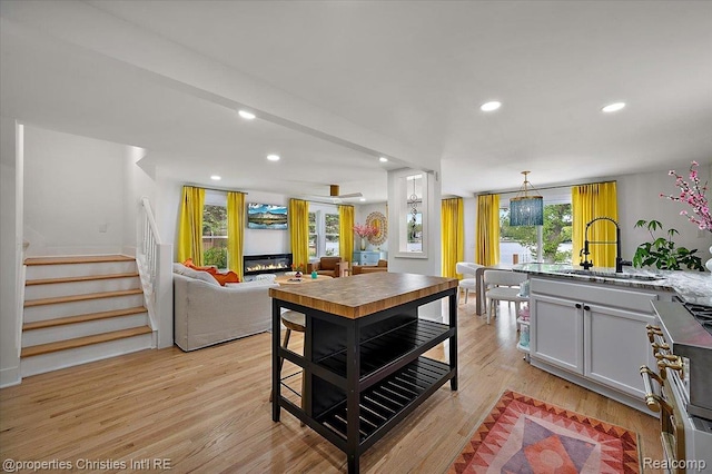 600 Wolverine Dr, Walled Lake, MI 48390 - kitchen featuring a sink, high end range, light wood-type flooring, recessed lighting, and open floor plan