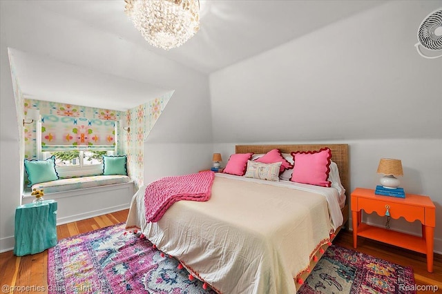 600 Wolverine Dr, Walled Lake, MI 48390 - bedroom with wood finished floors, vaulted ceiling, a chandelier, and baseboards