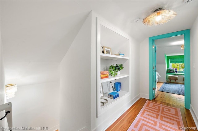 600 Wolverine Dr, Walled Lake, MI 48390 - corridor featuring wood-type flooring and vaulted ceiling