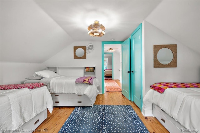 600 Wolverine Dr, Walled Lake, MI 48390 - bedroom with light wood finished floors and lofted ceiling