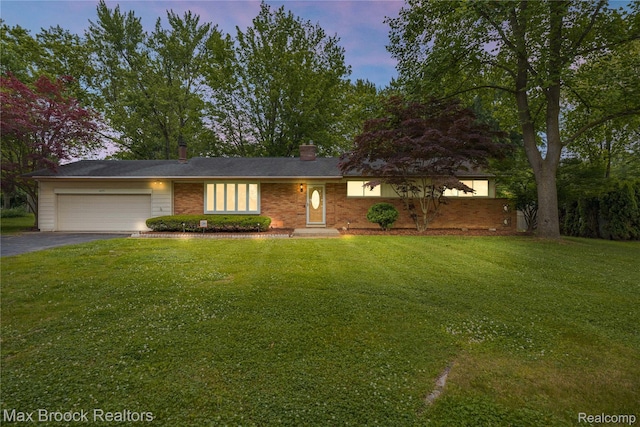 6695 Lahser Rd, Bloomfield Hills, MI 48301 - view of front of property with an attached garage, driveway, and a front lawn