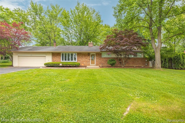 6695 Lahser Rd, Bloomfield Hills, MI 48301 - view of front of house with asphalt driveway, a garage, and a front yard