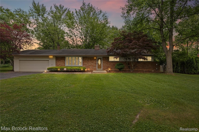 6695 Lahser Rd, Bloomfield Hills, MI 48301 - view of front of home with an attached garage, asphalt driveway, a lawn, and a chimney