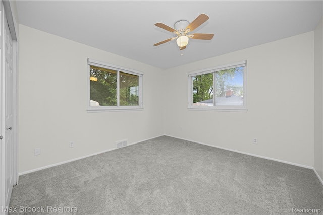 6695 Lahser Rd, Bloomfield Hills, MI 48301 - carpeted spare room with plenty of natural light and a ceiling fan