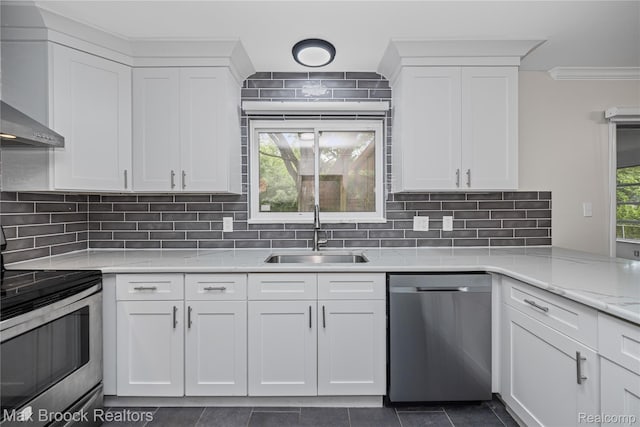 6695 Lahser Rd, Bloomfield Hills, MI 48301 - kitchen featuring stainless steel appliances, wall chimney exhaust hood, ornamental molding, white cabinets, and decorative backsplash