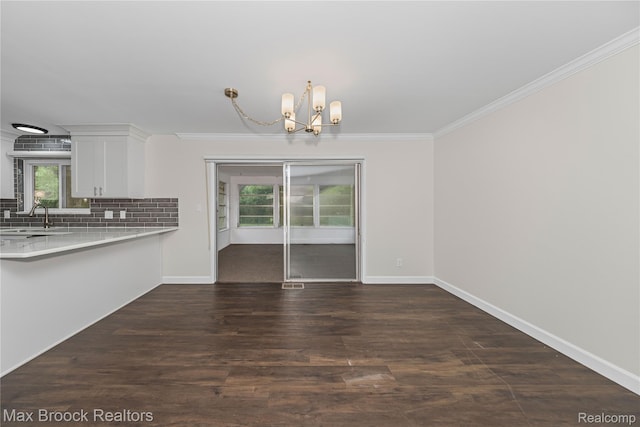 6695 Lahser Rd, Bloomfield Hills, MI 48301 - unfurnished dining area featuring a chandelier, ornamental molding, and dark wood-style flooring