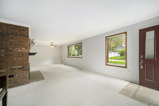 2800 Kimberley Rd, Ann Arbor, MI 48104 - unfurnished living room featuring a brick fireplace, carpet, plenty of natural light, ornamental molding, and ceiling fan