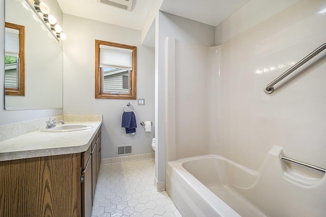2800 Kimberley Rd, Ann Arbor, MI 48104 - full bathroom with vanity, toilet, tile patterned floors, tub / shower combination, and baseboards