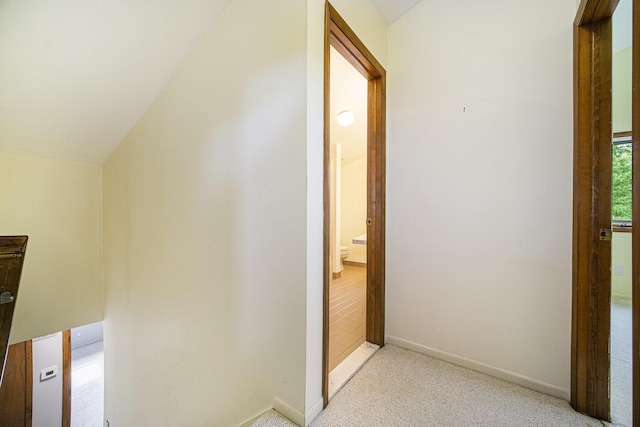 2800 Kimberley Rd, Ann Arbor, MI 48104 - hallway with lofted ceiling, light carpet, and baseboards