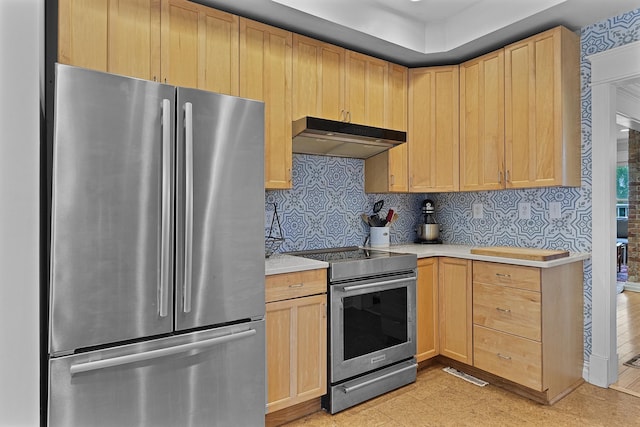 1118 Main St, Saint Joseph, MI 49085 - kitchen with stainless steel appliances, under cabinet range hood, and light brown cabinetry