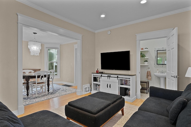 1118 Main St, Saint Joseph, MI 49085 - living room with a chandelier, light wood-type flooring, crown molding, baseboards, and recessed lighting