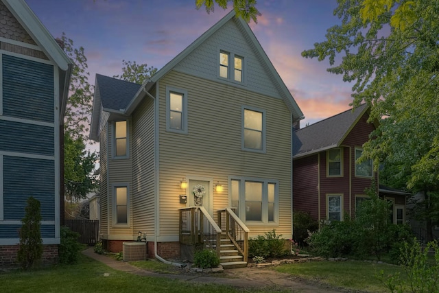 1118 Main St, Saint Joseph, MI 49085 - view of front facade with central AC unit and a front lawn