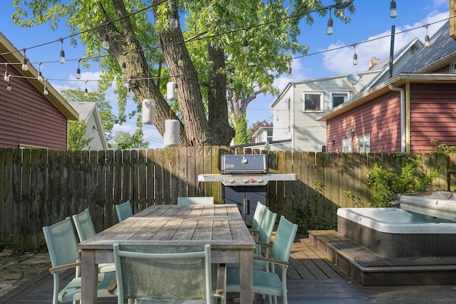 1118 Main St, Saint Joseph, MI 49085 - deck with a covered hot tub, a fenced backyard, outdoor dining space, and area for grilling