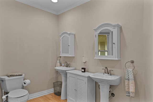 1118 Main St, Saint Joseph, MI 49085 - bathroom featuring crown molding, toilet, wood finished floors, and baseboards