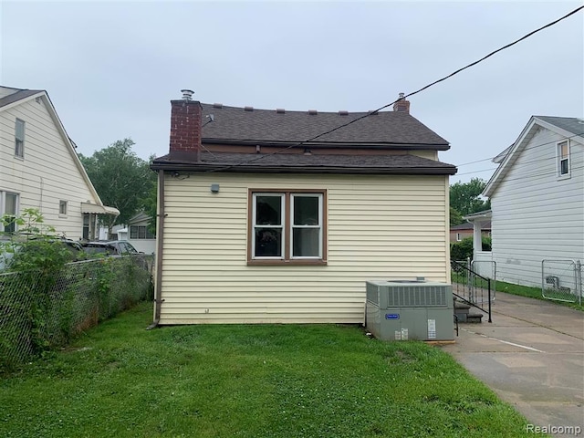 21731 Nevada Ave, Eastpointe, MI 48021 - back of house featuring a chimney, a patio area, and a shingled roof