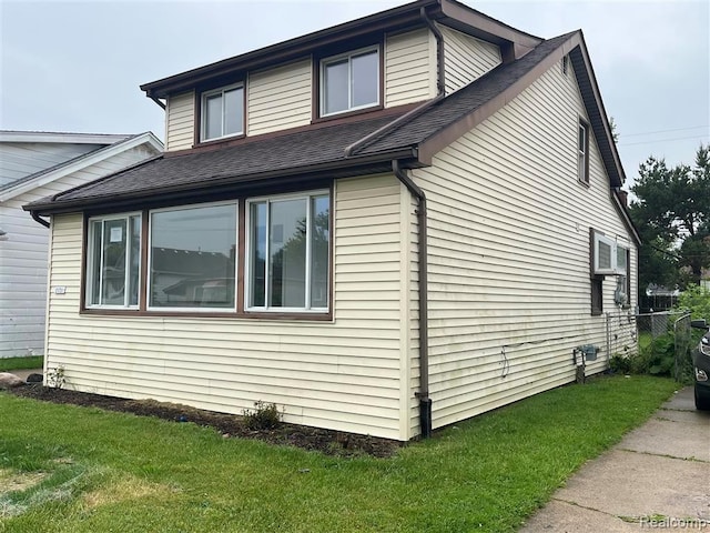 21731 Nevada Ave, Eastpointe, MI 48021 - view of side of home with roof with shingles and a lawn