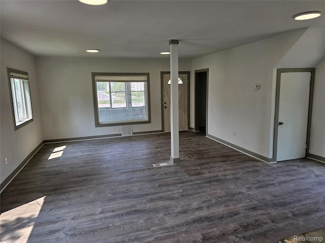 1073 W Bristol Rd, Grand Blanc, MI 48507 - unfurnished living room featuring baseboards and dark wood finished floors