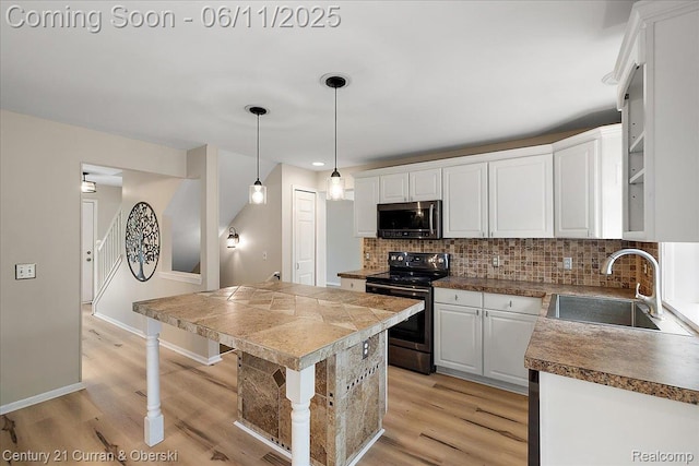 1134 Chestnut Ln, South Lyon, MI 48178 - kitchen with stainless steel appliances, a sink, backsplash, and white cabinetry