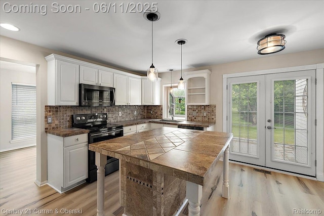 1134 Chestnut Ln, South Lyon, MI 48178 - kitchen featuring black electric range, open shelves, white cabinets, light wood finished floors, and tasteful backsplash