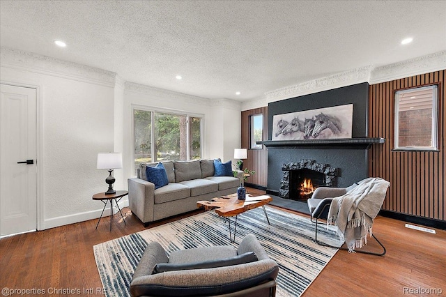 17155 Wisconsin St, Detroit, MI 48221 - living room with a textured ceiling, baseboards, wood finished floors, a warm lit fireplace, and recessed lighting