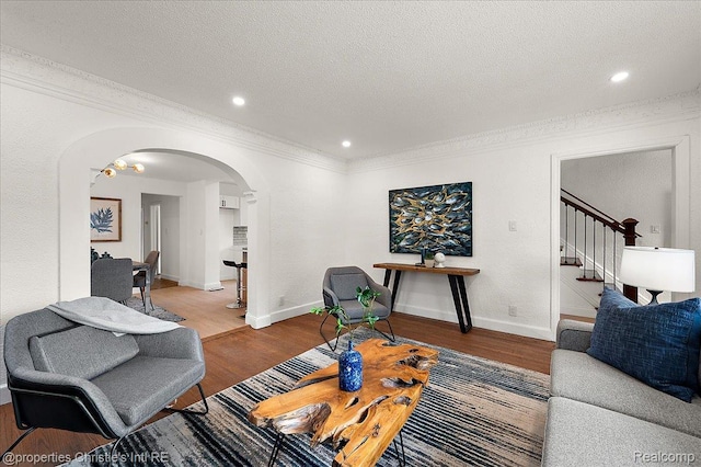 17155 Wisconsin St, Detroit, MI 48221 - living area with arched walkways, wood finished floors, a textured ceiling, crown molding, and baseboards