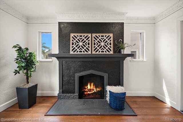 17155 Wisconsin St, Detroit, MI 48221 - detailed view of wood finished floors, baseboards, a fireplace, and ornamental molding