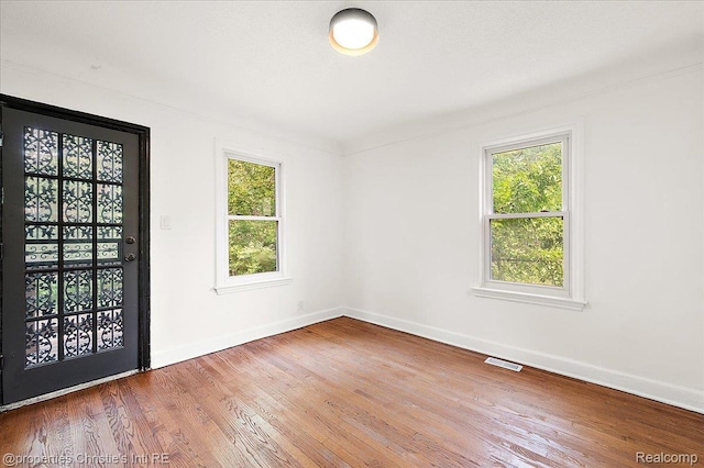 17155 Wisconsin St, Detroit, MI 48221 - empty room featuring healthy amount of natural light, baseboards, and wood finished floors
