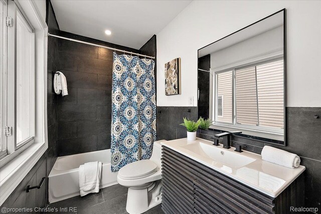 17155 Wisconsin St, Detroit, MI 48221 - full bathroom with vanity, tile walls, toilet, shower / bathtub combination with curtain, and tile patterned flooring