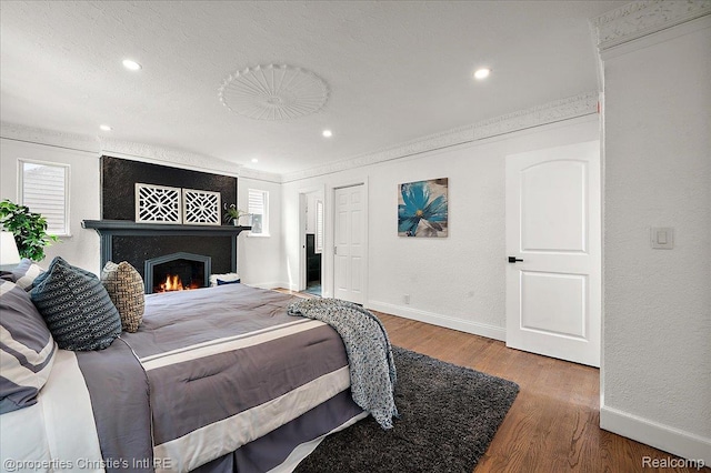 17155 Wisconsin St, Detroit, MI 48221 - bedroom with baseboards, wood finished floors, recessed lighting, a fireplace, and ornamental molding