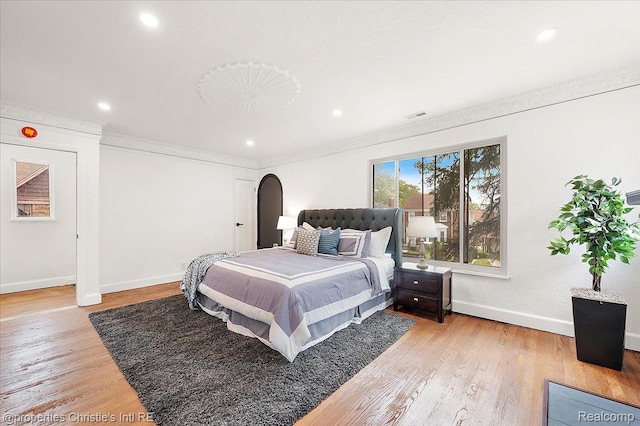 17155 Wisconsin St, Detroit, MI 48221 - bedroom with arched walkways, baseboards, light wood-style floors, recessed lighting, and crown molding