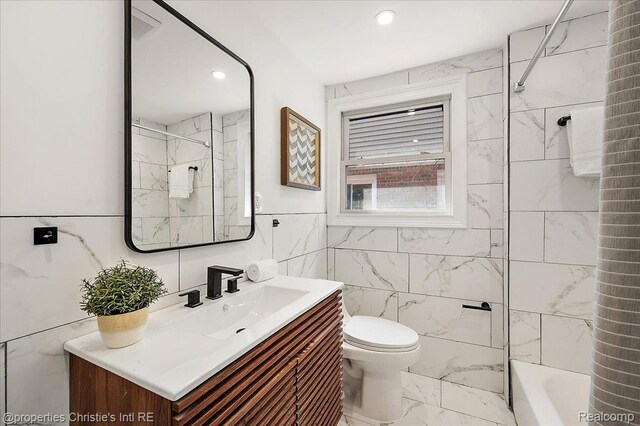 17155 Wisconsin St, Detroit, MI 48221 - bathroom featuring tile walls, marble look tiles, vanity, toilet, and  shower combination