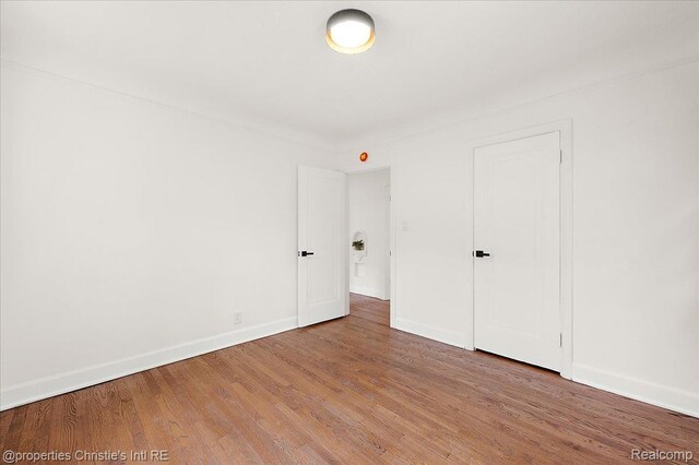 17155 Wisconsin St, Detroit, MI 48221 - unfurnished bedroom with wood finished floors and baseboards