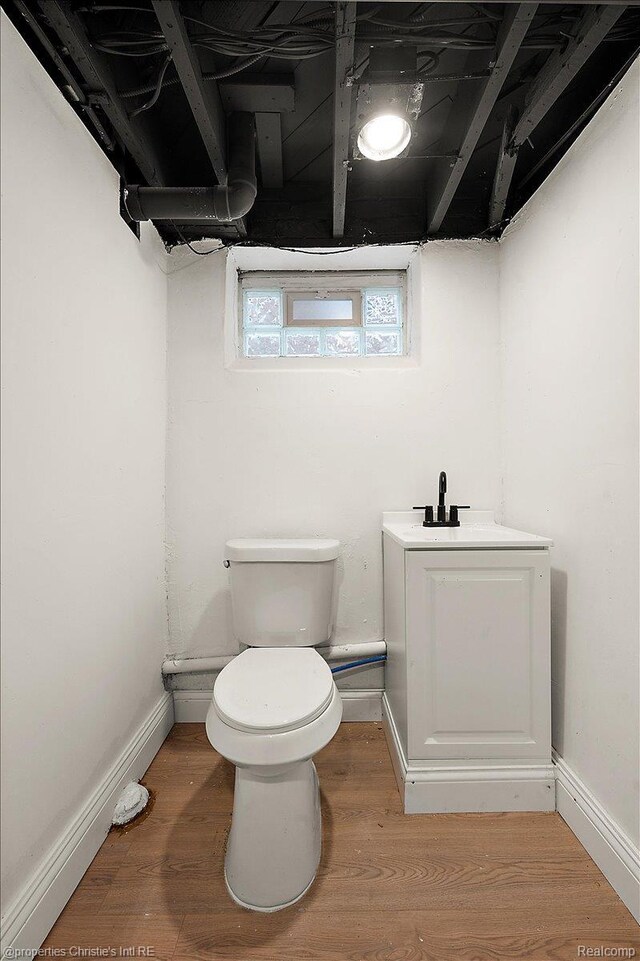 17155 Wisconsin St, Detroit, MI 48221 - half bathroom featuring toilet, wood finished floors, a sink, and baseboards