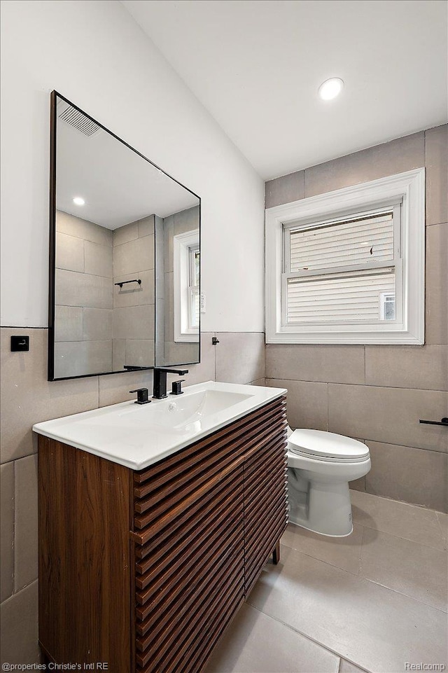 17155 Wisconsin St, Detroit, MI 48221 - bathroom featuring tile walls, vanity, toilet, and tile patterned floors