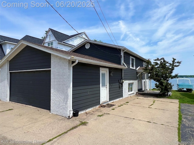 1869 Union Lake Rd, Commerce Twp, MI 48382 - view of front facade with a garage, brick siding, and driveway