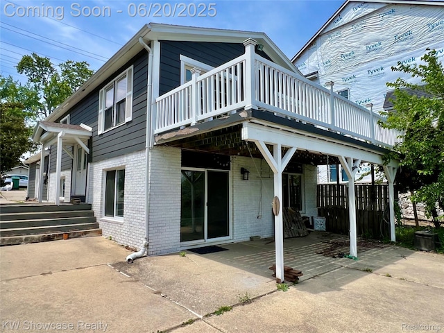 1869 Union Lake Rd, Commerce Twp, MI 48382 - back of property with brick siding, a deck, and a patio area