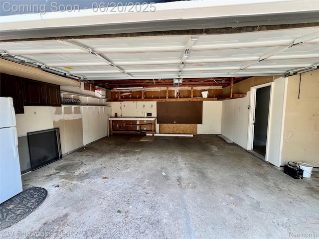 1869 Union Lake Rd, Commerce Twp, MI 48382 - garage featuring freestanding refrigerator and a garage door opener