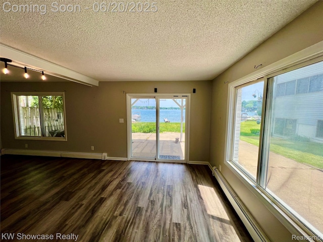 1869 Union Lake Rd, Commerce Twp, MI 48382 - unfurnished room featuring a baseboard radiator, dark wood-style flooring, a textured ceiling, a water view, and rail lighting