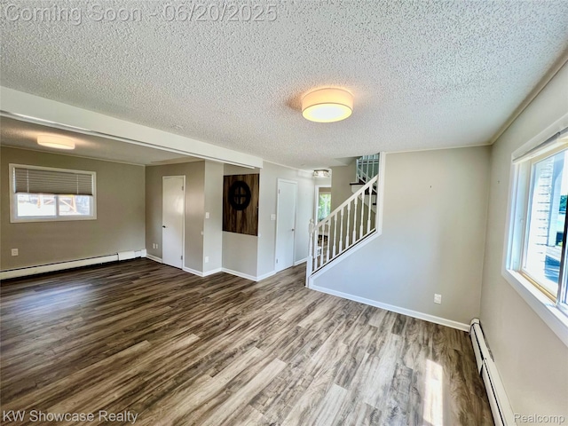 1869 Union Lake Rd, Commerce Twp, MI 48382 - spare room with a baseboard heating unit, wood finished floors, stairs, and a textured ceiling