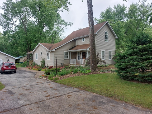 70170 Ironwood Dr, Niles, MI 49120 - traditional-style house featuring a porch, asphalt driveway, a front lawn, and roof with shingles