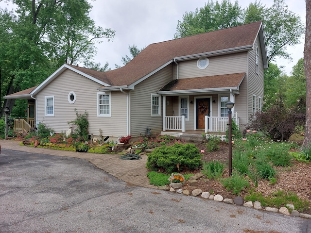 70170 Ironwood Dr, Niles, MI 49120 - view of front of home featuring a porch, a shingled roof, and driveway