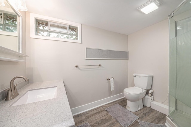 455 N 10th St, Plainwell, MI 49080 - bathroom with toilet, wood finished floors, a stall shower, vanity, and baseboards