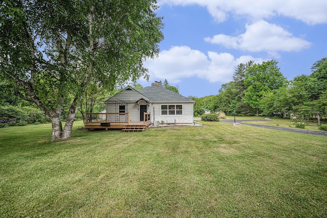 455 N 10th St, Plainwell, MI 49080 - view of front facade with a front lawn, a deck, and a chimney