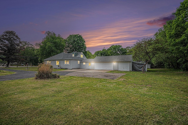 455 N 10th St, Plainwell, MI 49080 - rear view of house with driveway and a lawn