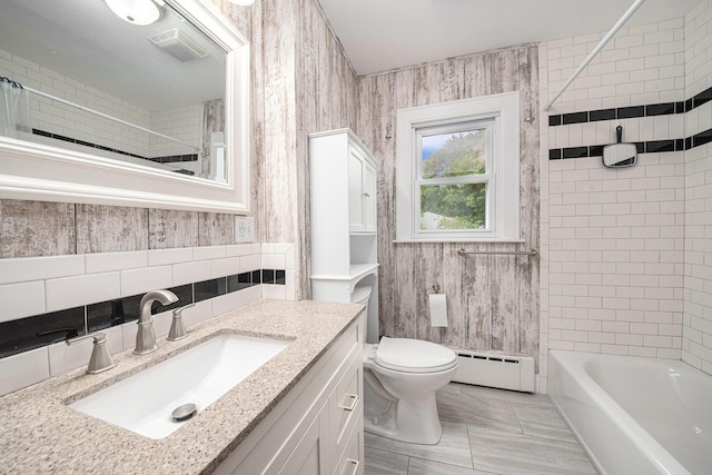 455 N 10th St, Plainwell, MI 49080 - full bath with baseboard heating, vanity, toilet, and shower / bathtub combination with curtain