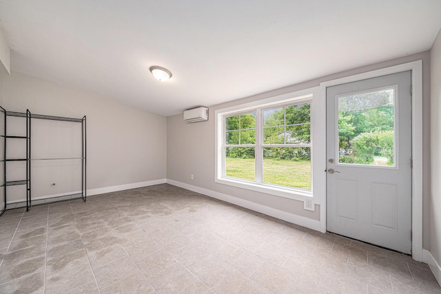 455 N 10th St, Plainwell, MI 49080 - unfurnished bedroom with a wall unit AC, multiple windows, baseboards, and light tile patterned flooring