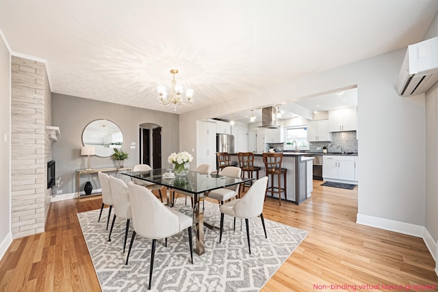 455 N 10th St, Plainwell, MI 49080 - dining space with baseboards, a chandelier, and light wood-style floors
