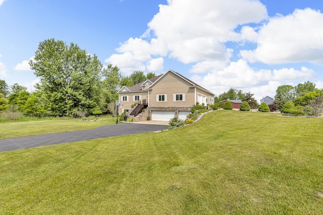 7910 Stony Lake Rd, Jackson, MI 49201 - view of front facade featuring stone siding, a garage, driveway, a front lawn, and stairs